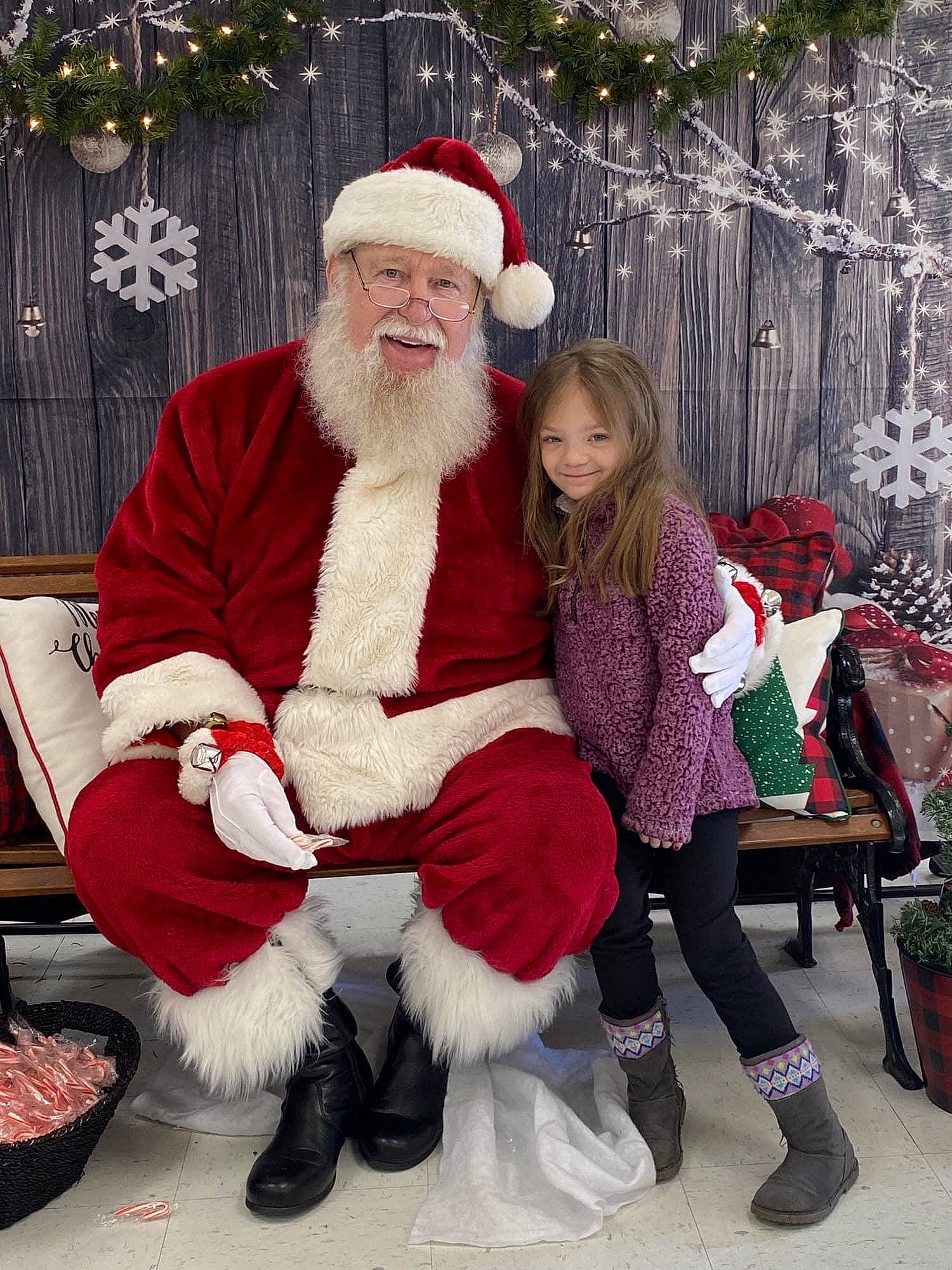 Makayla is registered to the contest to win money with this photo: beard, christmas, christmas_decoration, event, face, facial_hair, fictional_character, fun, hair, happy, hat, headwear, holiday, joy, lap, person, red, santa_claus, shoe, smile