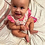 baby, bedspread, child, cute, eyes, face, feet, hair, hands, happy, indoors, infant, mouth, person, pink_clothing, polka_dot, sitting, skin, smiling, toy