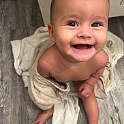 Shiloh joined the competition — help win amazing prizes! baby, barefoot, child, cute, expression, eyes, face, floor, happy, head, indoors, infant, mouth, person, sitting, skin, smiling, toes, towel, young