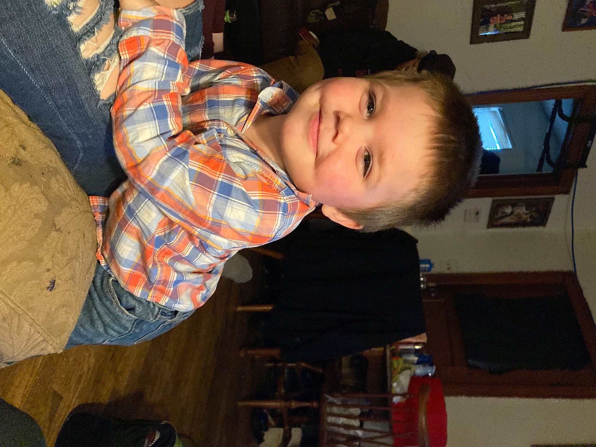 Ethan is registered to the contest to win money with this photo: baby, cheek, child, comfort, ear, elbow, eye, fun, happy, iris, joy, mouth, nose, pattern, person, plaid, room, sitting, smile, tartan