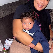 Shakeel joined the competition — help win amazing prizes! woman, baby, child, indoor, smile, holding, couch, pillow, clothing, hair, person, furniture, relaxed, casual, footwear, skin, happy, portrait, can, floor