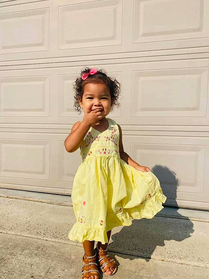 Charlie Rose is registered to the contest to win money with this photo: baby_toddler_clothing, child, child_model, clothing, day_dress, dress, fashion_accessory, fashion_design, footwear, formal_wear, joy, pattern, person, photography, shoulder, sleeve, smile, toddler, white, yellow