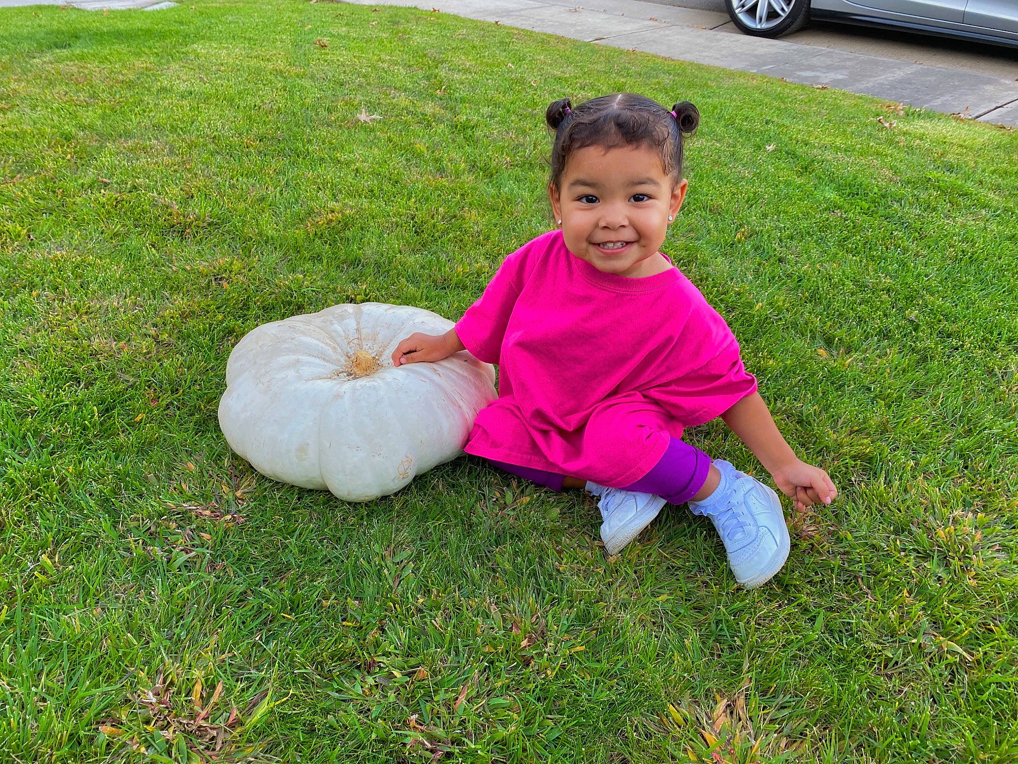 Charlie Rose is registered to the contest to win money with this photo: baby, car, child, grass, grass_family, head, joy, lawn, leaf, person, pink, plant, play, sitting, smile, summer, toddler, vacation, vehicle, yard
