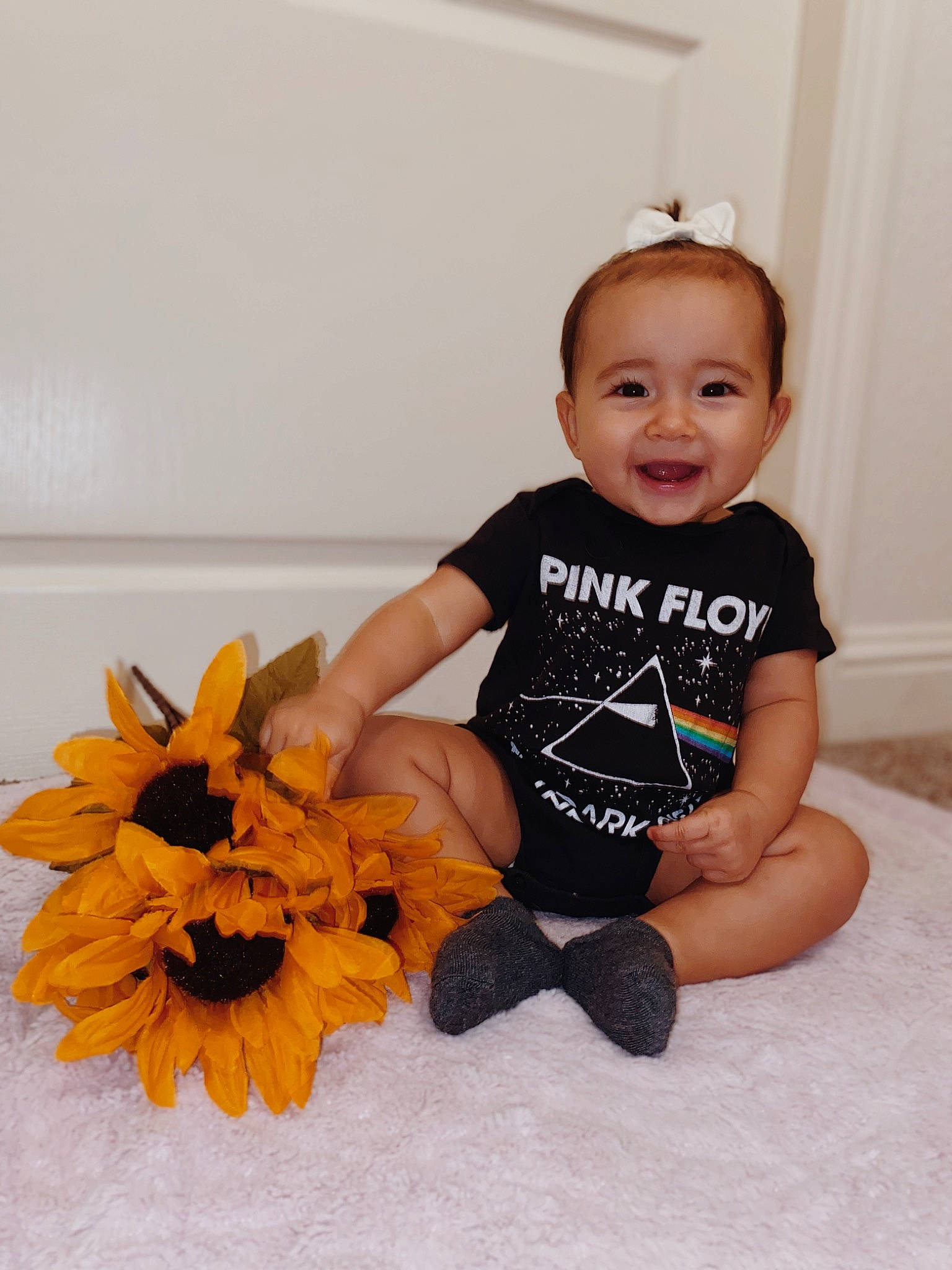 Carter is registered to the contest to win money with this photo: arm, baby, baby_products, baby_toddler_clothing, calabaza, child, costume, flower, hair_accessory, happy, joy, person, plant, sitting, sunflower, t_shirt, toddler, yellow
