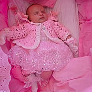 Kalilah-Rose joined the competition — help win amazing prizes! baby, sleeping, pink_clothing, crocheted_sweater, lace_dress, soft_blankets, cushions, newborn, infant, cozy, indoor, cute, child, warm, resting, glitter, decorative, peaceful, portrait, small