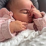 baby, blanket, child, closed_eyes, comfort, cozy, cushion, cute, face, hand, indoors, infant, newborn, peaceful, pink_clothing, portrait, resting, sleeping, soft_texture, toddler