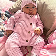 Ceylan participe au concours pour gagner de l'argent avec cette photo : baby, bed, blanket, buttoned_suit, child, cozy, cute, hat, indoor, infant, knitwear, mickey_mouse, pillow, pink_clothing, portrait, resting, serious_face, sleepwear, socks, soft_toys