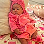 Ceylan a rejoint le concours — aidez-le/la à gagner de superbes lots ! baby, pink, robe, head_wrap, slippers, bedspread, hearts, infant, cute, soft, indoor, resting, comfortable, child, portrait, sleepwear, apparel, hand, footwear, person