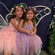 Ovi joined the competition — help win amazing prizes! child, children, girl, girls, flower_crown, tutu, dress, purple_dress, pink_dress, hug, smile, chair, butterfly_wings, indoor, decoration, greenery, happy, barefoot, portrait, celebration