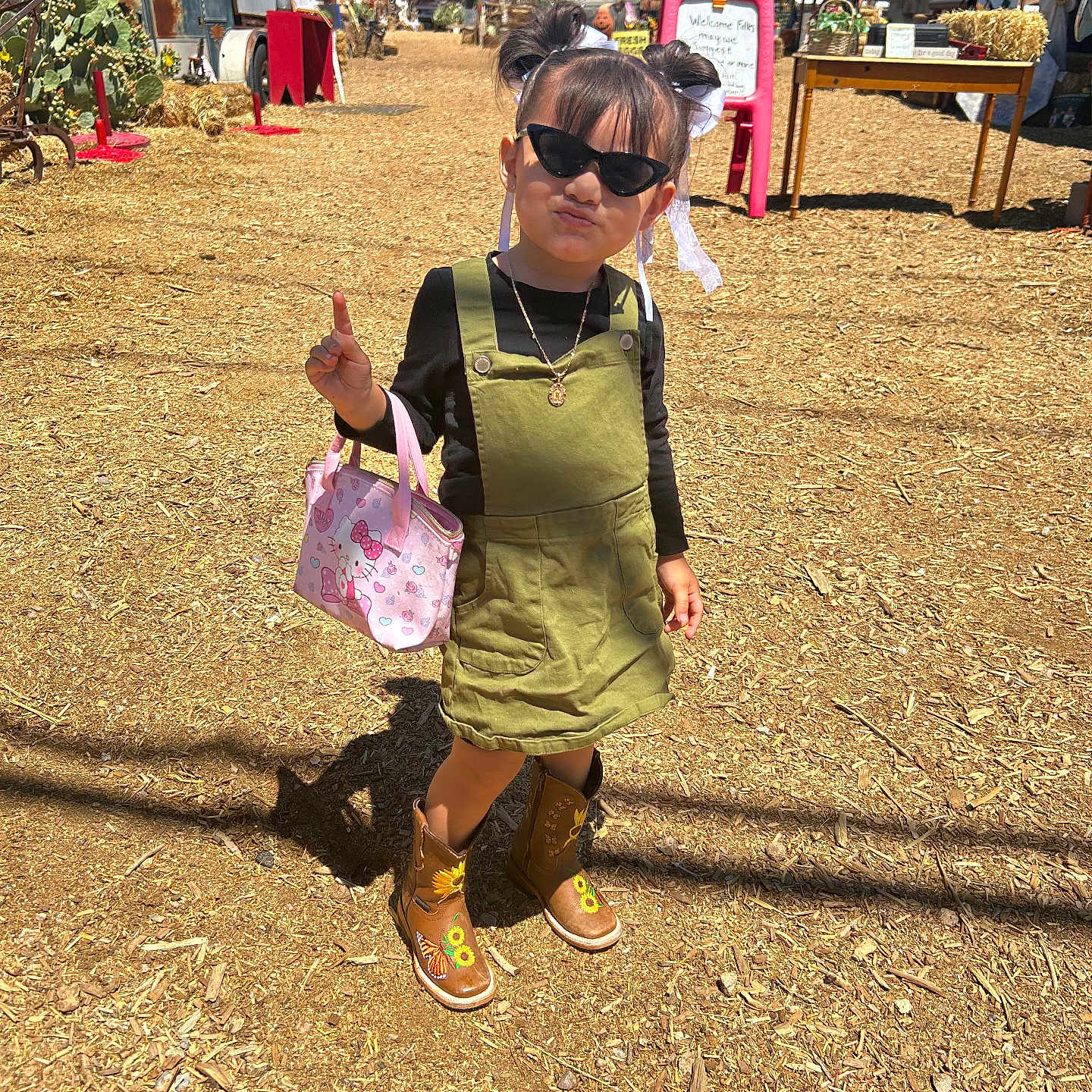 Eliana joined the competition — help win amazing prizes! boots, butterfly, child, dirt_ground, dress, farm, fashion, girl, handbag, hello_kitty, necklace, outdoor, pigtails, playful, pose, ribbons, shadow, sunflower, sunglasses, sunlight