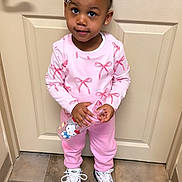 Amoura-Reign is registered to the contest to win money with this photo: beige_door, braided_hair, casual_wear, child, curious_expression, cute, door, earrings, floor_tiles, hair_bow, hello_kitty, holding_object, indoor, pink_clothing, portrait, sneakers, standing, toddler, water_bottle, young_child