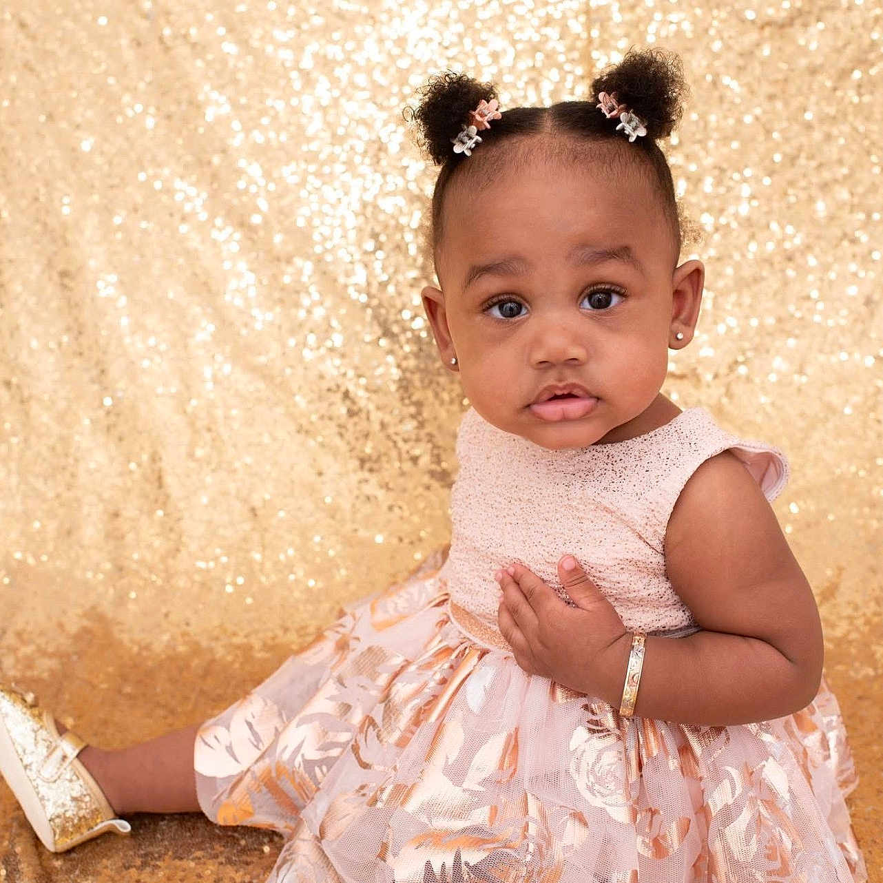 Amoura-Reign is registered to the contest to win money with this photo: bracelet, child, curious_expression, cute, dress, earrings, face, fashion, flower_clips, girl, golden_shoes, hairstyle, indoor, person, portrait, sitting, sparkling_background, studio_photo, toddler, young_child