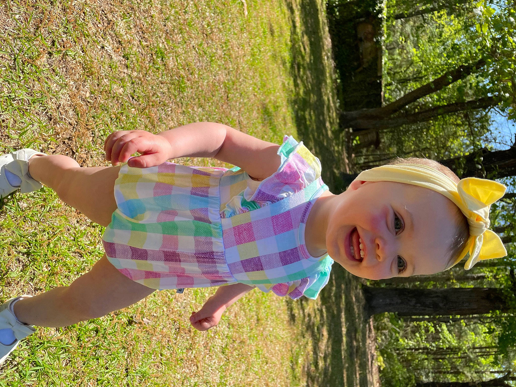 Molly joined the competition — help win amazing prizes! eyewear, fun, grass, grass_family, happy, human_leg, lawn, leaf, leisure, pattern, people_in_nature, person, pink, plaid, plant, recreation, smile, sunlight, thigh, toddler