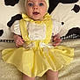 adorable, baby, blanket, blue_eyes, bow, child, cute, headband, indoors, infant, lying_down, patterned_blanket, portrait, puffy_sleeves, ribbons, smiling, soft_texture, white_socks, yellow_dress, young