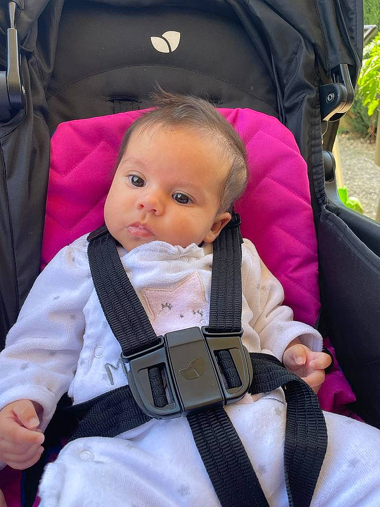 Myla participe au concours pour gagner de l'argent avec cette photo : baby, baby_carriage, baby_products, baby_safety, baby_toddler_clothing, black, cheek, child, comfort, face, facial_expression, hairstyle, head, lap, person, photograph, plant, skin, sleeve, toddler