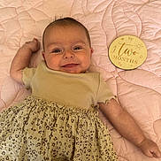 Ivy joined the competition — help win amazing prizes! baby, infant, smiling, two_months, quilt, pink, clothing, leopard_print, dress, cute, lying_down, milestone_marker, happy, face, child, skin, soft, indoors, portrait, young