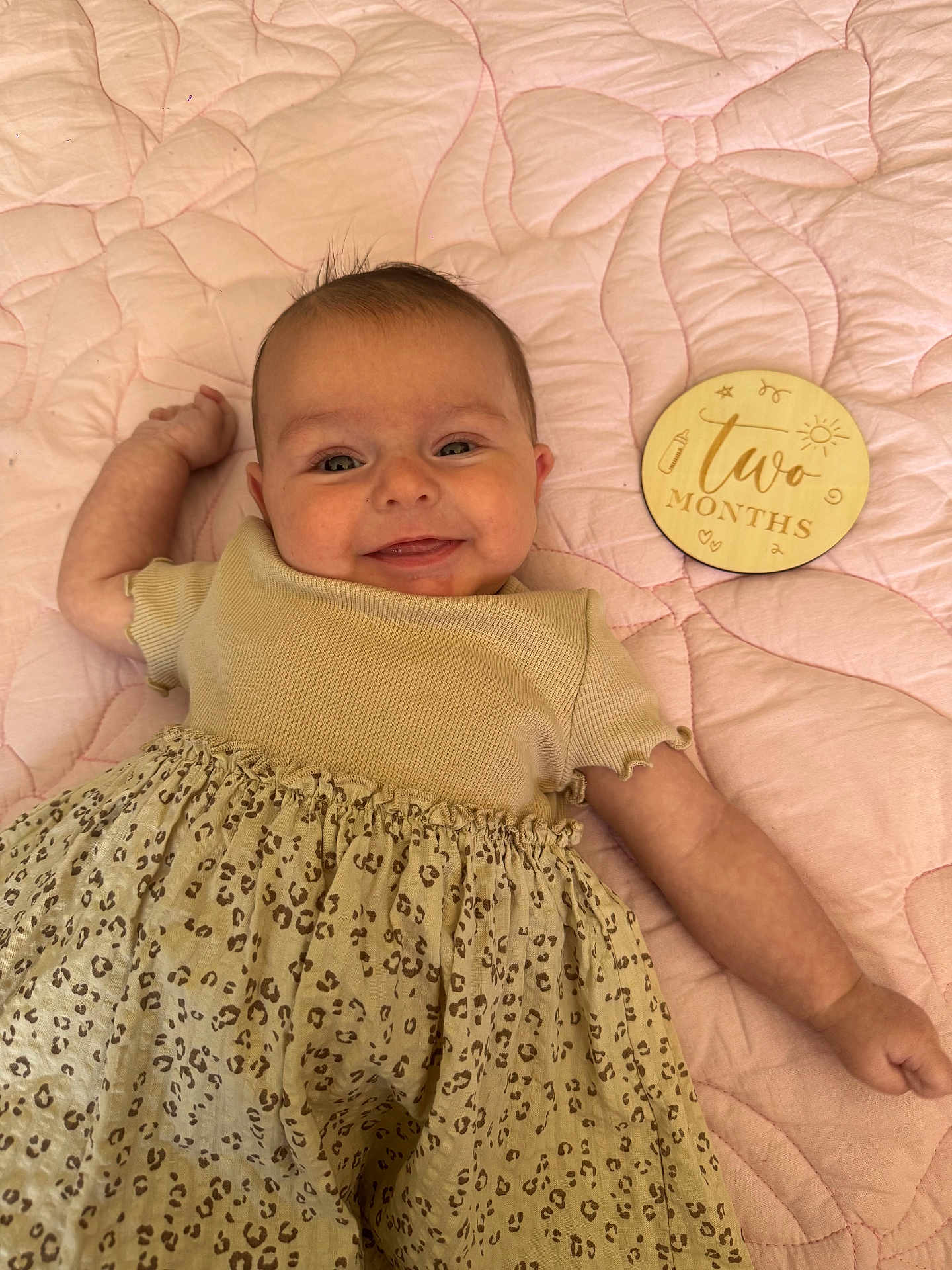 Ivy joined the competition — help win amazing prizes! baby, infant, smiling, two_months, quilt, pink, clothing, leopard_print, dress, cute, lying_down, milestone_marker, happy, face, child, skin, soft, indoors, portrait, young