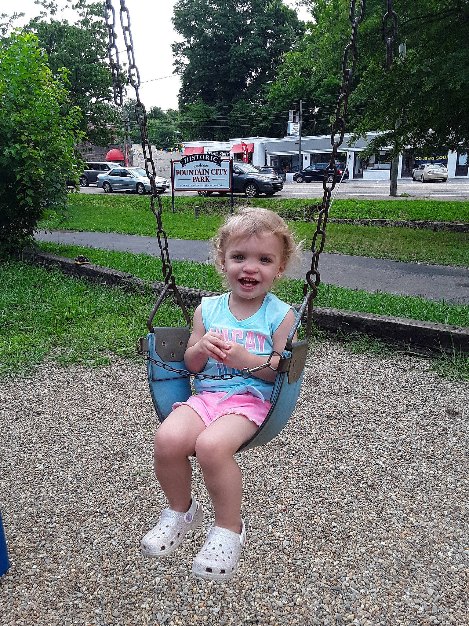 Leeanah is registered to the contest to win money with this photo: baby, baby_toddler_clothing, car, city, electric_blue, fun, grass, happy, joy, leisure, outdoor_play_equipment, person, plant, playground, recreation, sitting, sky, swing, t_shirt, toddler