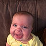 Rubyann joined the competition — help win amazing prizes! baby, infant, child, smiling, tongue_out, portrait, close_up, face, eyes, yellow_clothing, onesie, seated, couch, indoor, home, happy, cute, looking_at_camera, photograph, head