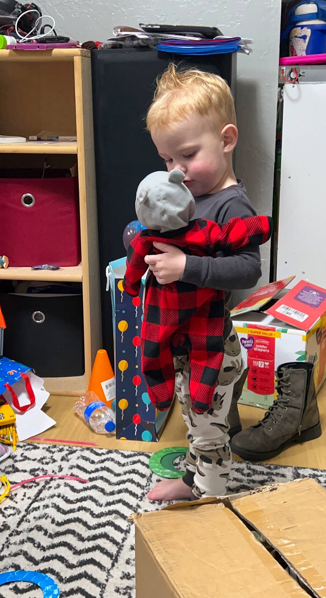 Deklan joined the competition — help win amazing prizes! baby, baby_toddler_clothing, bag, bookcase, cabinetry, child, drawer, flooring, fun, holiday, pajamas, pattern, person, plaid, play, room, sitting, t_shirt, tartan, toddler