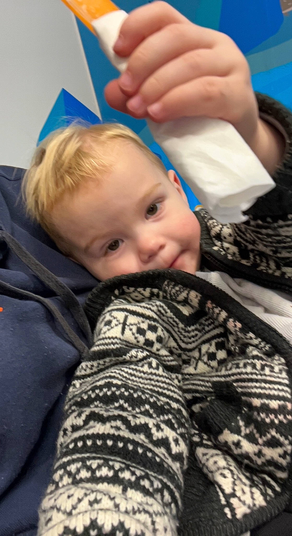 Deklan is registered to the contest to win money with this photo: baby, baby_toddler_clothing, cheek, child, comfort, gesture, happy, human_body, human_leg, linens, nail, pattern, person, sitting, skin, smile, textile, thumb, toddler, wood