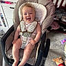 baby, smiling, baby_rocker, infant, nursery, toys, plush_toy, carpet, crib, clothing, child, happy, indoor, seat, person, furniture, baby_clothes, playroom, infant_seat, cute