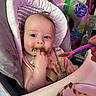 baby, high_chair, food, messy, feeding, green_food, spoon, child, infant, face, clothing, hand, mealtime, cute, indoor, person, pink, seat, expression, hair
