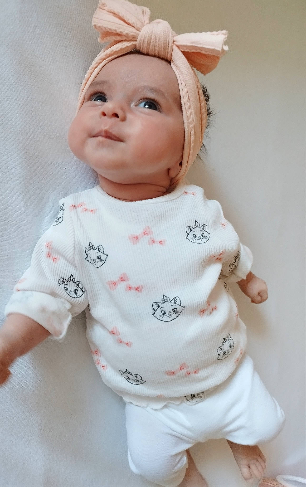 Ava participe au concours pour gagner de l'argent avec cette photo : baby_toddler_clothing, cheek, child, doll, eyebrow, eyelash, hairstyle, happy, head, human_body, lip, nose, outerwear, peach, person, pink, skin, sleeve, toy, vertebrate