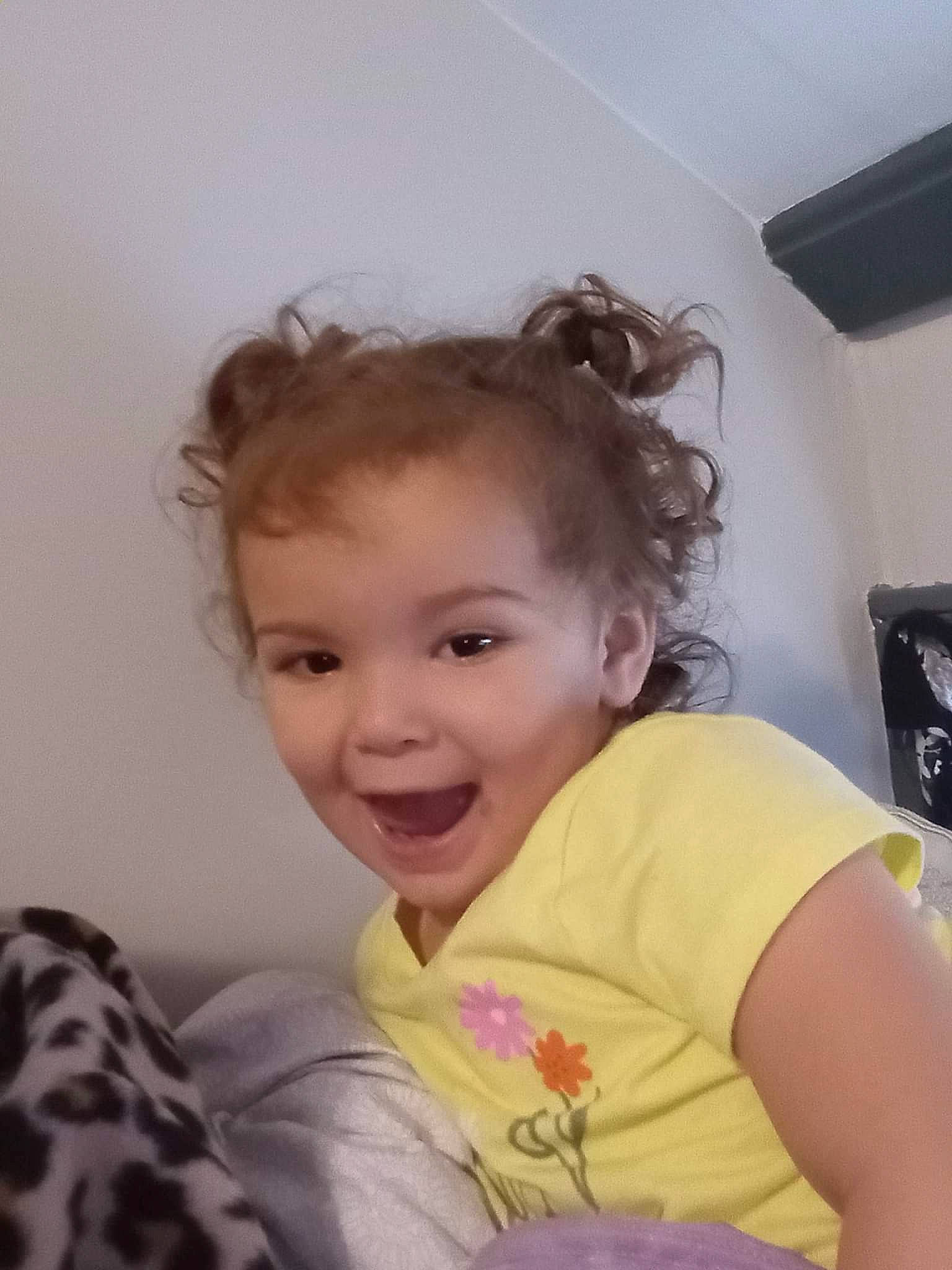 Ivy Rose is registered to the contest to win money with this photo: arm, baby_toddler_clothing, cheek, child, comfort, couch, eyelash, fun, gesture, happy, iris, lip, long_hair, magenta, nose, person, sitting, skin, sleeve, smile