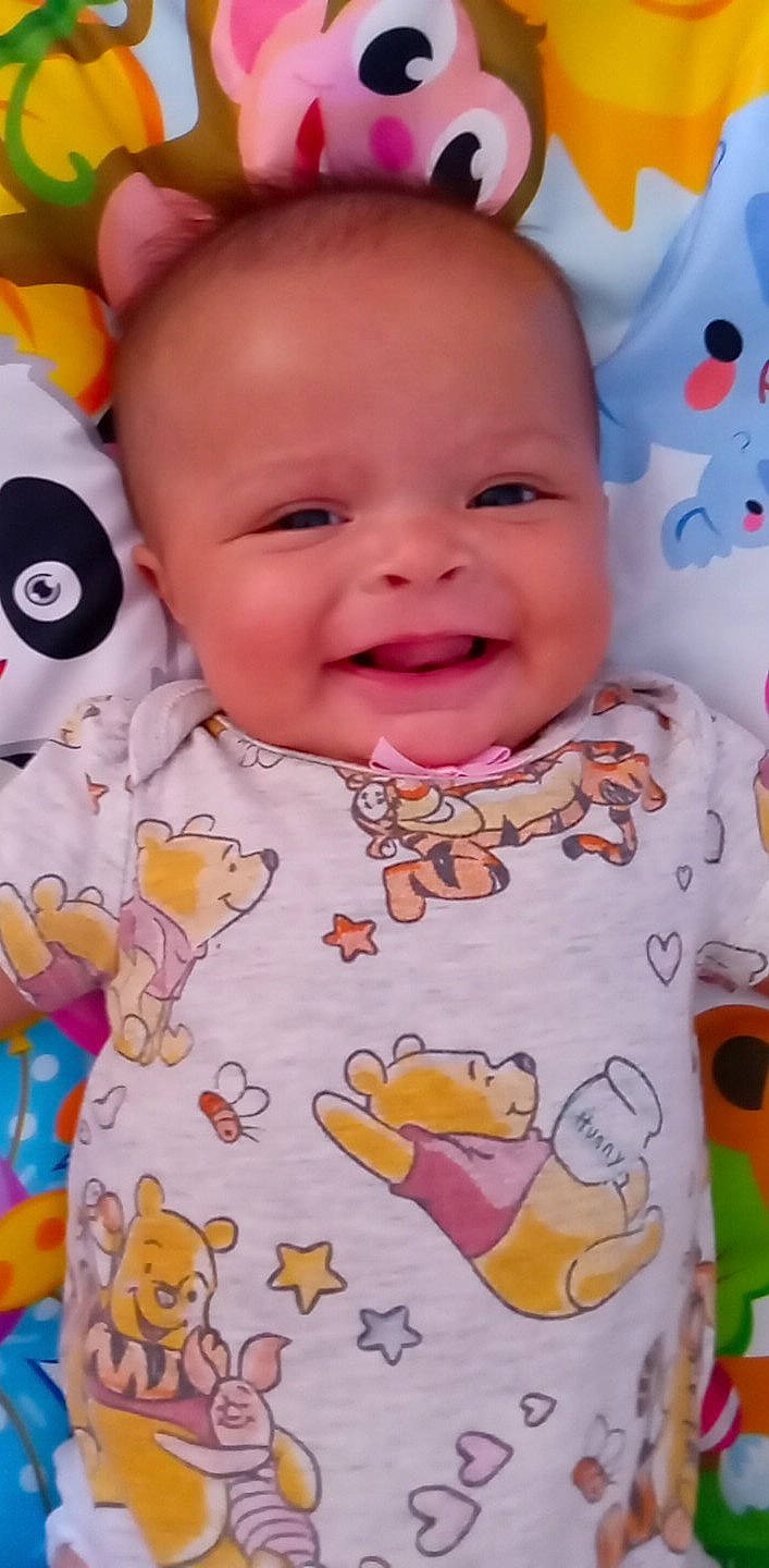 Elodie joined the competition — help win amazing prizes! baby, baby_toddler_clothing, cheek, chin, face, facial_expression, happy, iris, joy, nose, orange, organ, outerwear, person, pink, product, skin, sleeve, smile, textile