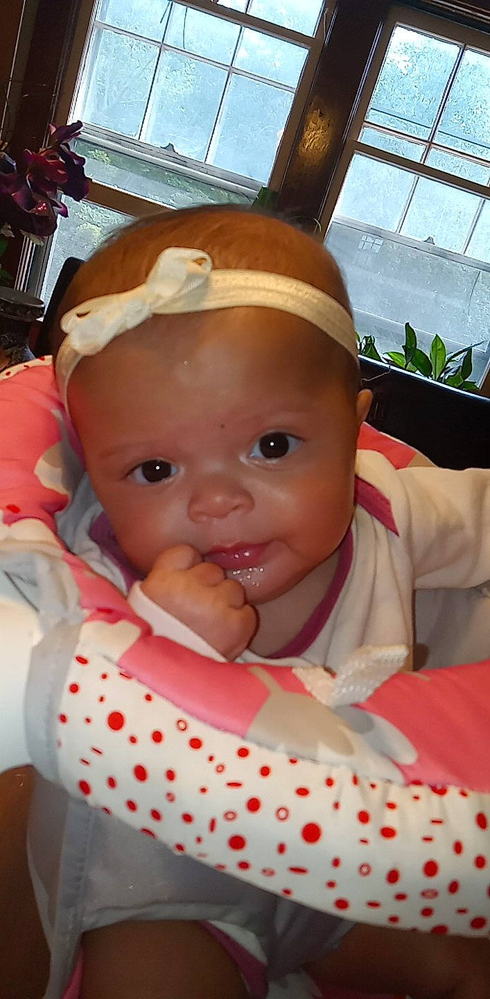 Elodie is registered to the contest to win money with this photo: baby, baby_products, baby_toddler_clothing, bib, carmine, cheek, child, chin, event, fun, happy, hat, lip, mouth, nose, person, pink, plant, skin, toddler