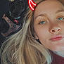 woman, dog, car_interior, selfie, blonde_hair, red_horns_filter, black_dog, plaid_harness, seat, window, daylight, pet, portrait, casual, face, human, animal, companion, indoors, vehicle