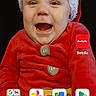 baby, child, smiling, santa_hat, red_clothing, holiday_outfit, portrait, face, infant, festive, cute, happy, indoors, app_icons, smartphone_screen, google_search_bar, button, clothing, person, screen