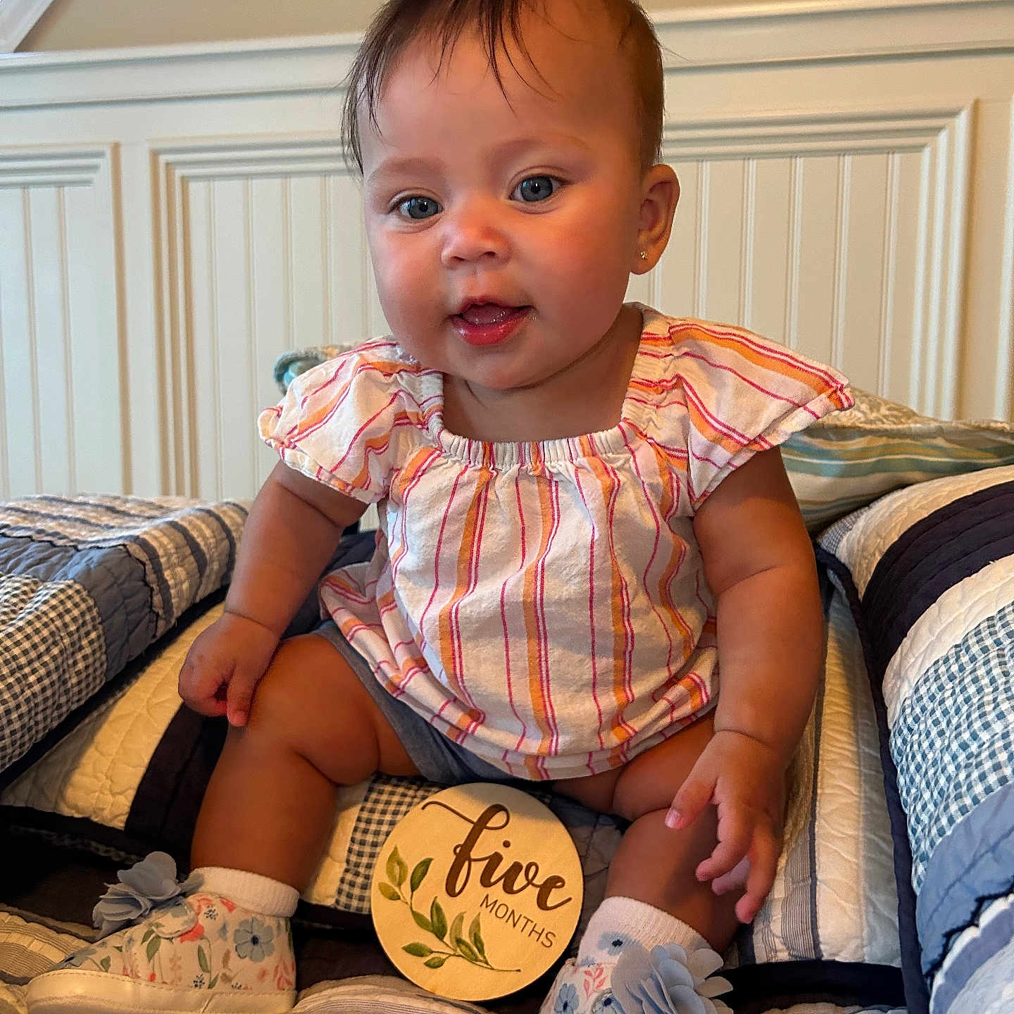 Jennifer is registered to the contest to win money with this photo: baby, ball, clothing, couch, cushion, face, football, footwear, furniture, head, homedecor, person, photography, portrait, shoe, shorts, sitting, sneaker, soccer, soccerball