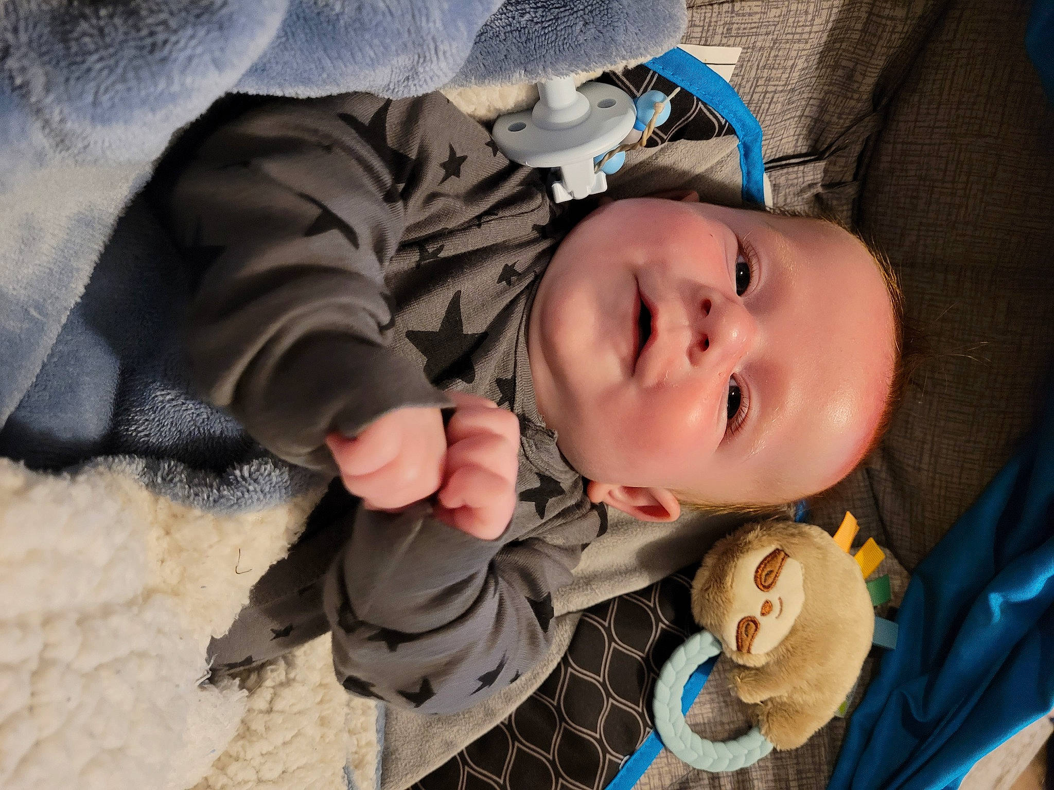 Brayden is registered to the contest to win money with this photo: baby, baby_toddler_clothing, blue, cheek, chin, comfort, eye, eyebrow, eyelash, human_body, iris, lip, mammal, mouth, nose, person, skin, sleeve, smile, toddler