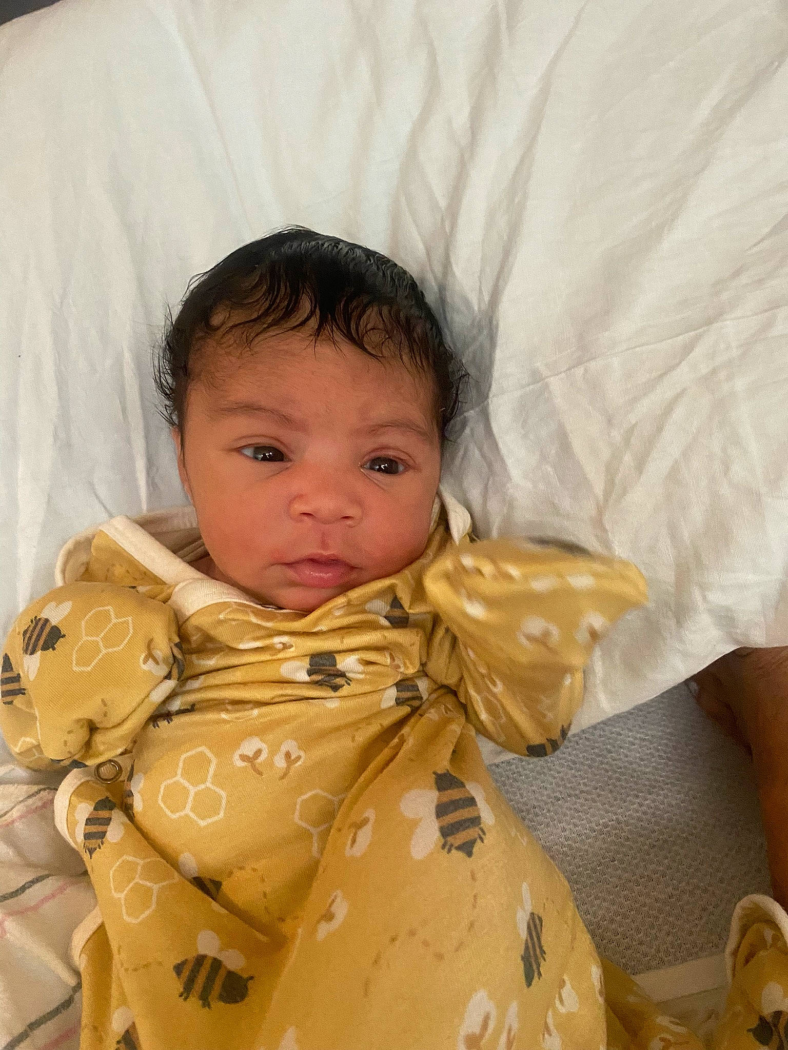 Amara is registered to the contest to win money with this photo: baby, baby_toddler_clothing, bag, bedtime, cheek, child, comfort, eye, face, happy, head, iris, linens, nose, person, plastic_bag, sitting, skin, sleeve, textile