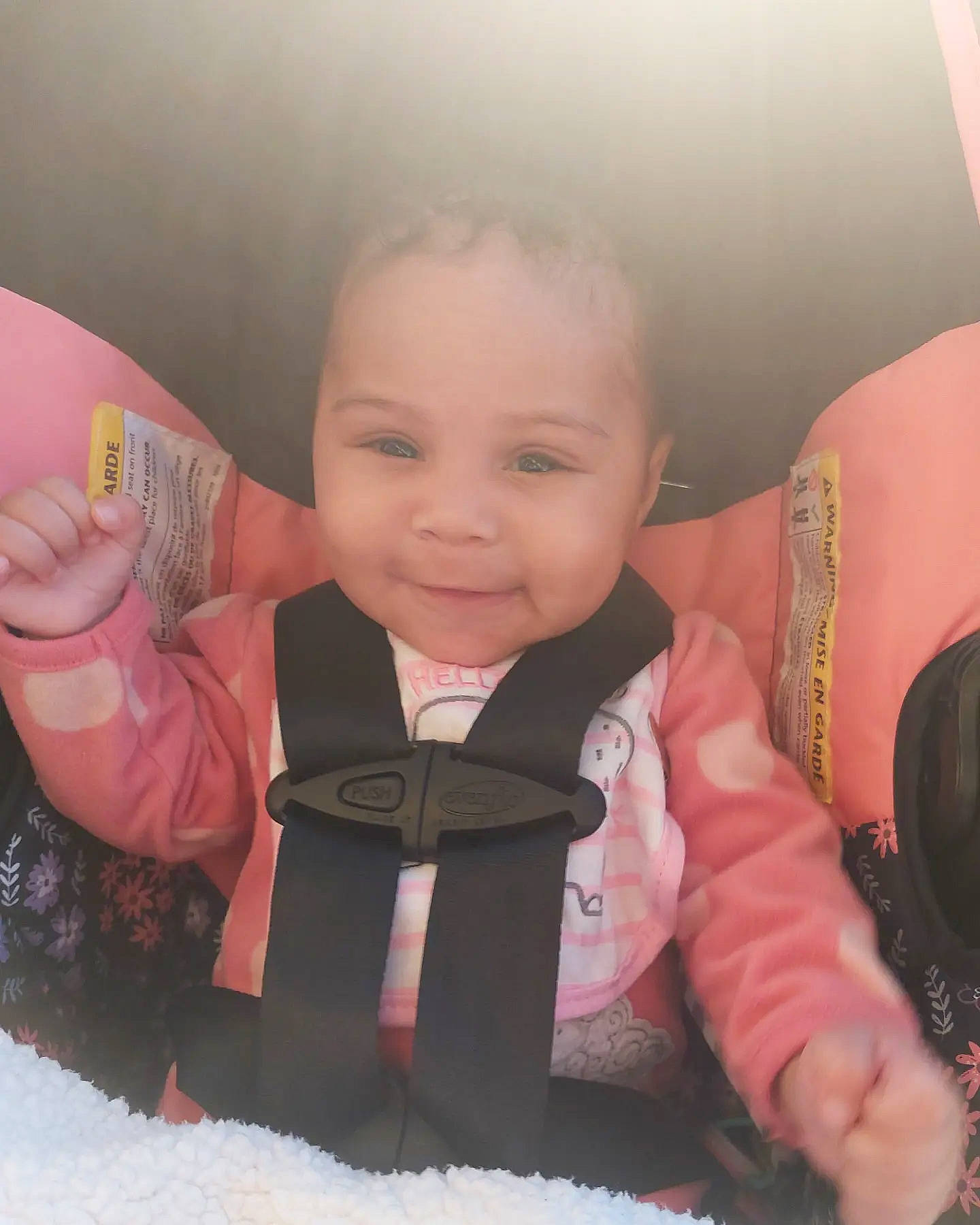 Amara is registered to the contest to win money with this photo: baby_toddler_clothing, cheek, chin, eye, facial_expression, finger, gesture, hairstyle, happy, head, human_body, iris, joy, lip, mouth, neck, nose, outerwear, person, skin