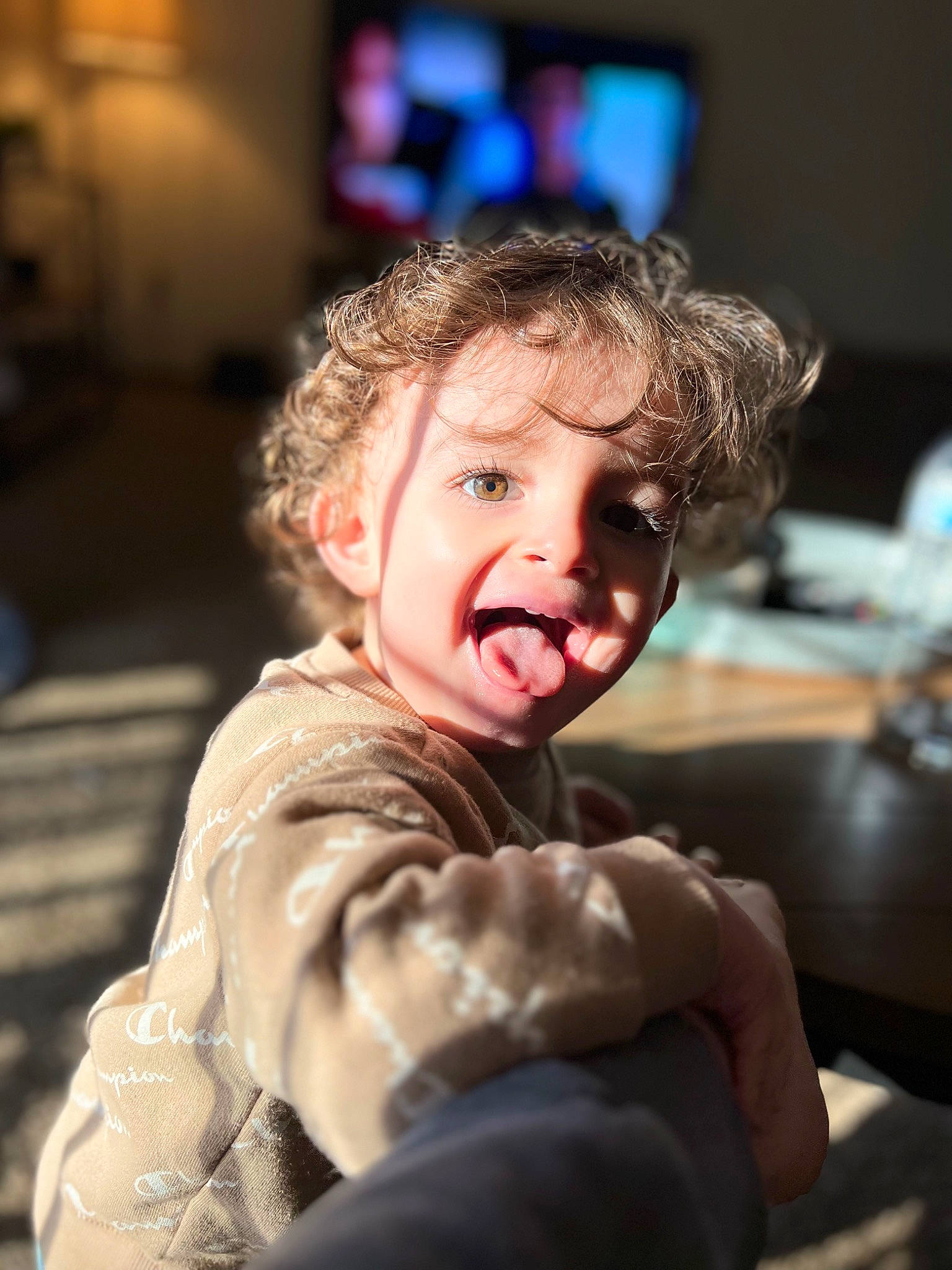 Haiden is registered to the contest to win money with this photo: baby, cheek, child, event, eye, flash_photography, fun, fur, hairstyle, happy, laugh, person, portrait_photography, room, sitting, table, toddler, vacation