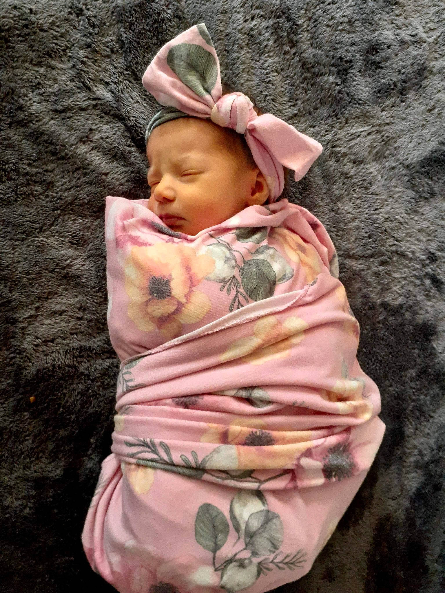 Rylee is registered to the contest to win money with this photo: baby, baby_toddler_clothing, cap, child, face, fashion_accessory, finger, grass, head, human_body, linens, lip, pattern, peach, person, pink, sitting, skin, sleeve, sun_hat