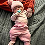 Everlynn joined the competition — help win amazing prizes! baby, pink_clothing, knit_hat, pom_poms, pacifier, blanket, orange_blanket, gray_blanket, infant, lying_down, cozy, soft_toys, knit_booties, cute, child, sleepwear, indoors, portrait, newborn, resting