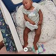 Kymani joined the competition — help win amazing prizes! baby, sleeping, playpen, pillow, toy, infant, cozy, child, blanket, cute, peaceful, indoor, soft, resting, clothing, person, comfort, home, sleep, toddler