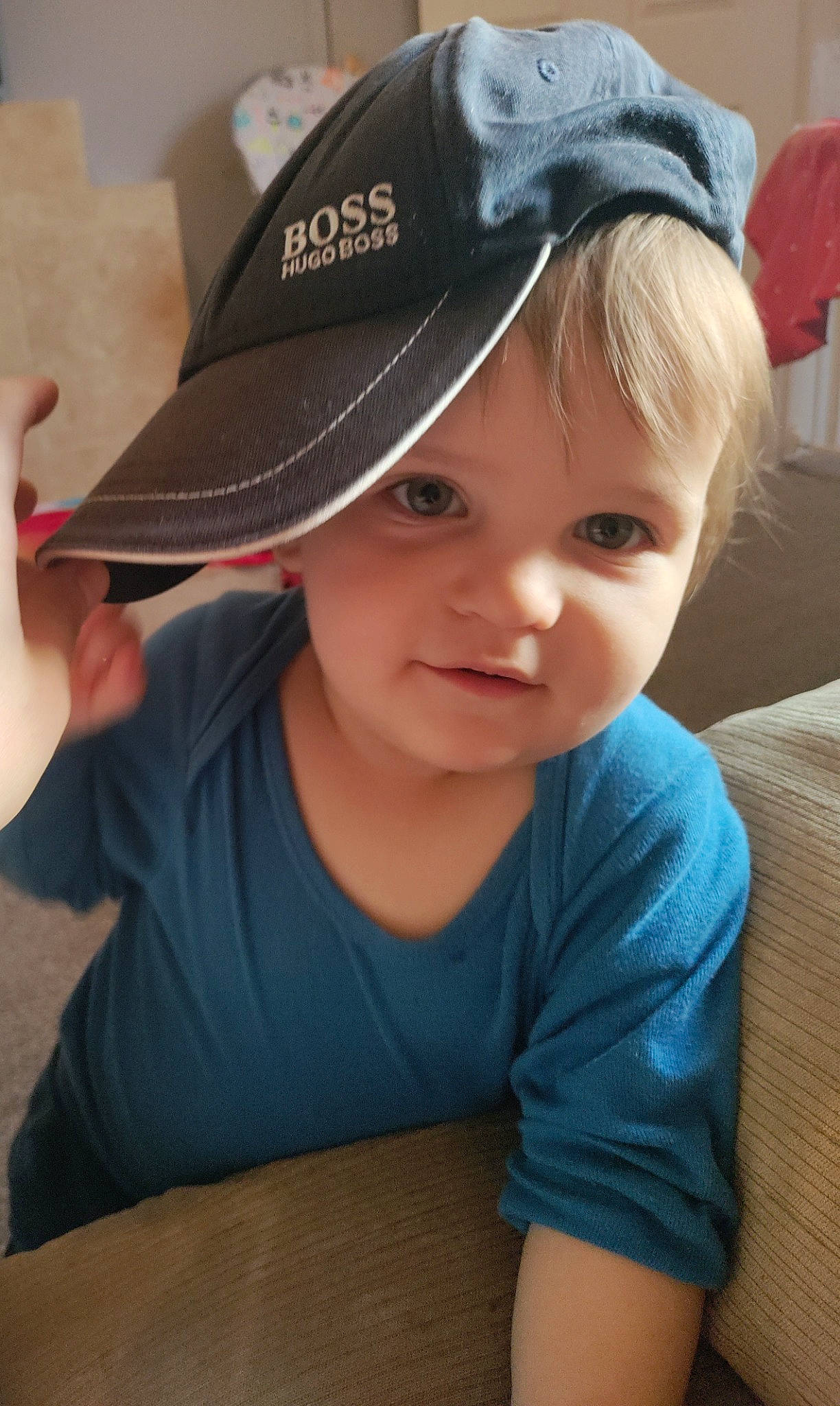 Denis joined the competition — help win amazing prizes! baseball_cap, cap, child, cricket_cap, electric_blue, fashion_accessory, finger, fun, happy, hat, headgear, headwear, person, personal_protective_equipment, sitting, sleeve, t_shirt, table, thumb, toddler