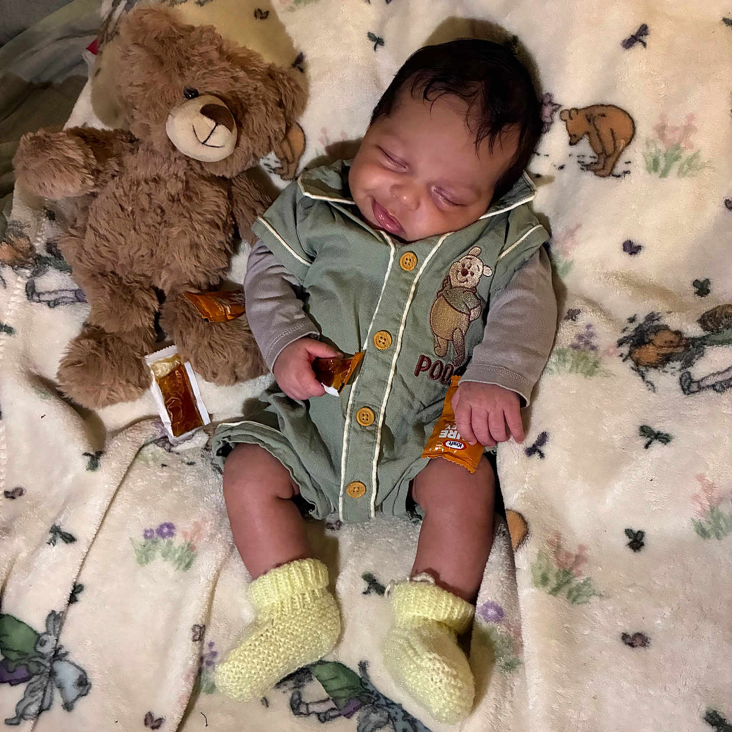 Dashine is registered to the contest to win money with this photo: baby, teddy_bear, blanket, sleeping, infant, soft_toy, cute, child, cozy, yellow_socks, green_outfit, animal_print, bedtime, peaceful, indoors, plush, small_packets, resting, portrait, comfort