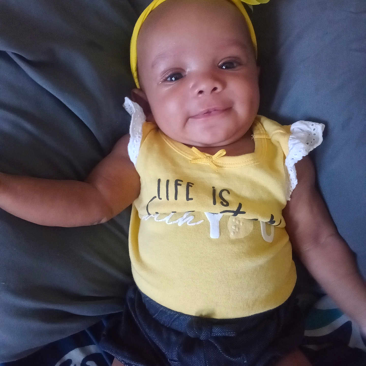 Zemaria is registered to the contest to win money with this photo: accessories, baby, bodypart, bonnet, cap, clothing, couch, face, finger, furniture, hand, hat, head, headband, newborn, person, photography, portrait, shorts, t_shirt