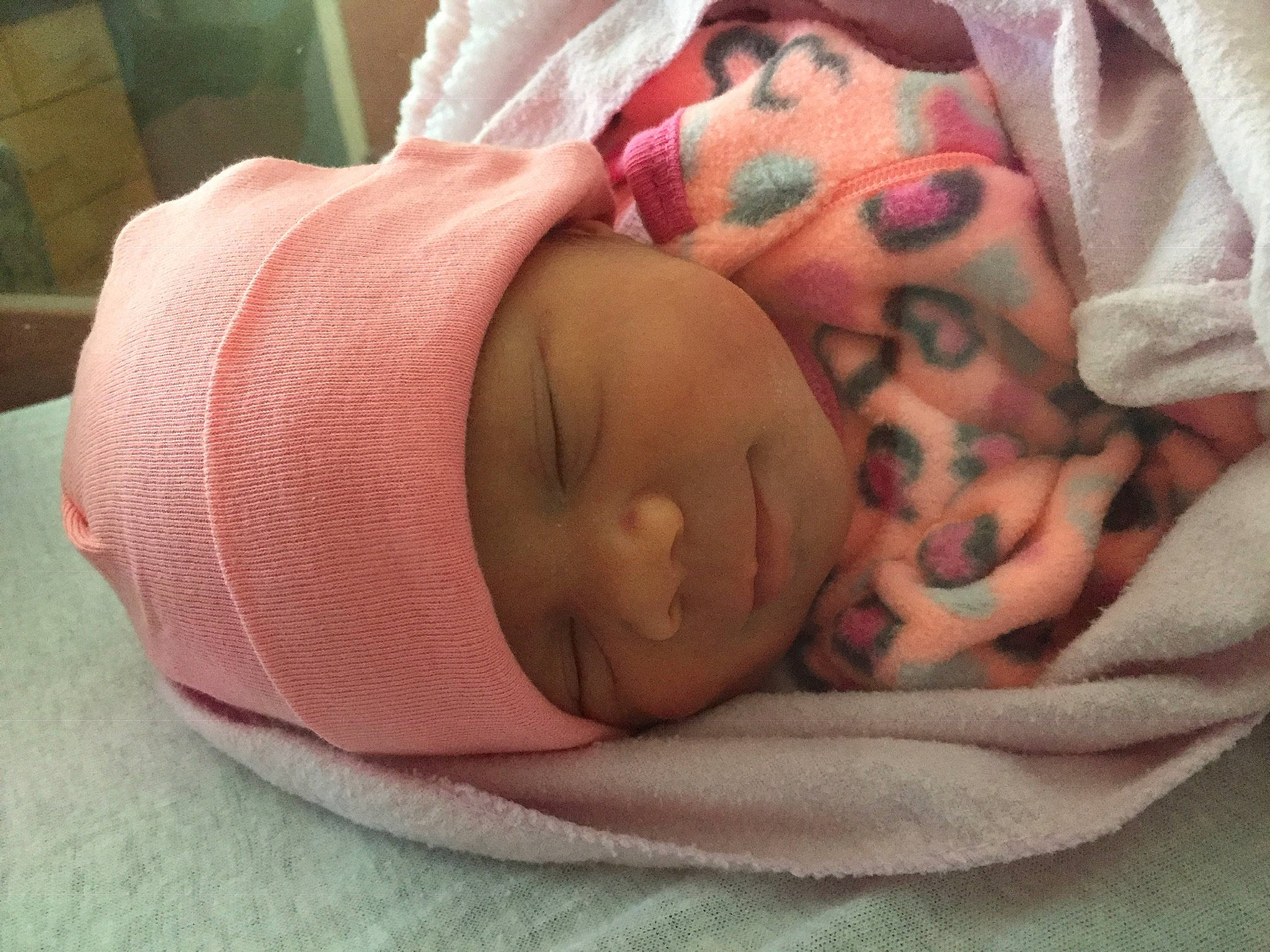 Amira is registered to the contest to win money with this photo: baby, baby_products, baby_sleeping, baby_toddler_clothing, bedtime, cheek, child, comfort, face, facial_expression, finger, hand, hat, headgear, headwear, linens, mouth, nose, person, pink