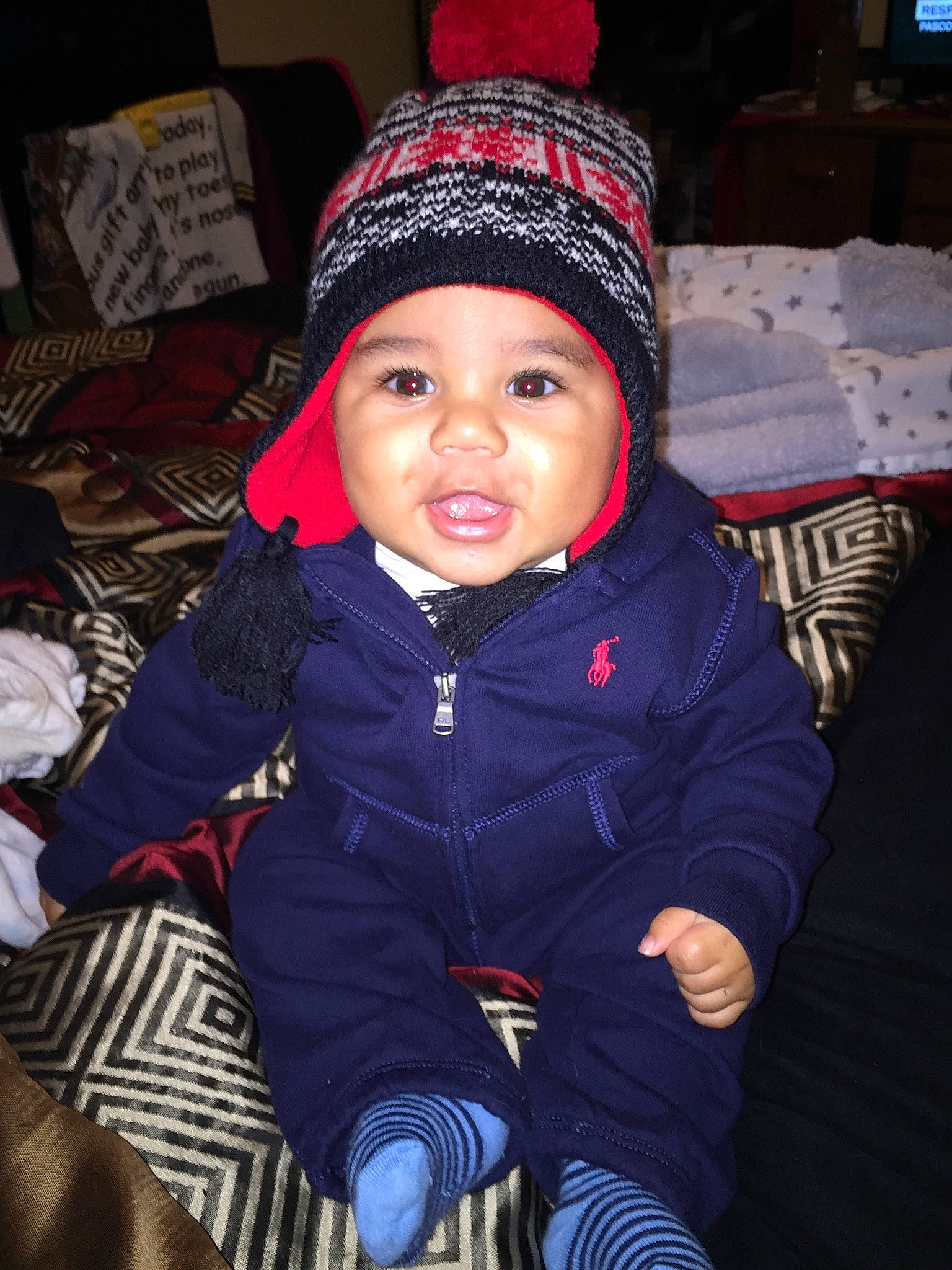 Davien joined the competition — help win amazing prizes! baby, baby_toddler_clothing, beanie, cap, cheek, child, comfort, cool, electric_blue, flash_photography, happy, headwear, jacket, knit_cap, person, purple, sitting, skin, sleeve, television