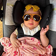 Amelia joined the competition — help win amazing prizes! baby, infant, child, car_seat, sunglasses, yellow_headband, bow, pink_blanket, bow_pattern, blanket, harness, seat_padding, stroller, portrait, hand, face, reflection, clothing, cute, comfort