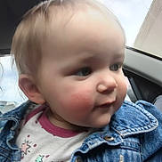 Calli is registered to the contest to win money with this photo: toddler, child, denim_jacket, face, cheeks, clothing, car_interior, window, sky, curious, portrait, young_child, casual, cute, indoor, closeup, person, head, hair, smile