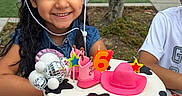 Aiza Grenevitch is registered to the contest to win money with this photo: child, birthday, birthday_cake, cowboy_hat, smiling, girl, outdoor, party, celebration, pink, cake, number_six, candles, dessert, family, park, table, disco_ball, denim, portrait