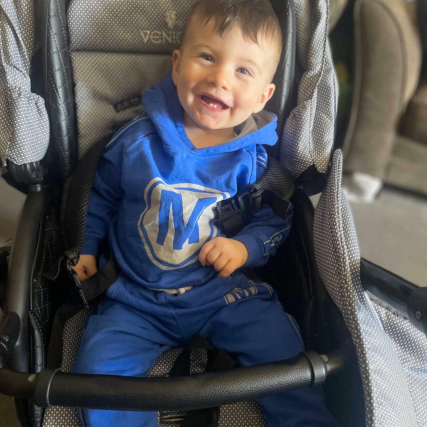 Noah joined the competition — help win amazing prizes! baby, babylaughing, buggy, clothing, coat, face, furniture, happy, head, jacket, jeans, pants, person, photography, portrait, sitting, smile, stroller, t_shirt, transportation